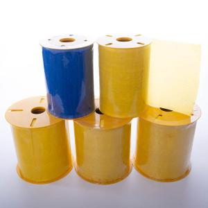 Stack of yellow and blue adhesive tape rolls arranged in two rows, with one blue roll on top among yellow rolls.