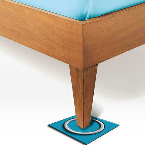 Bed Bug Trap for Bed Leg Sticky Board Glue Monitoring Board Fall Pest Control 12*12cm 1 Close-up of a wooden bed leg with a blue upholstered edge, standing on a blue floor protector with a metal ring on a white floor.