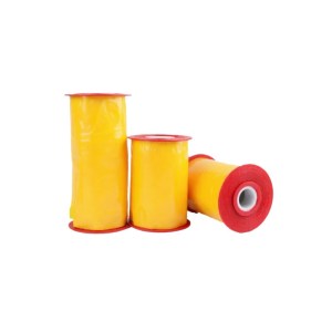 Three yellow sewing thread spools with red caps on a white background
