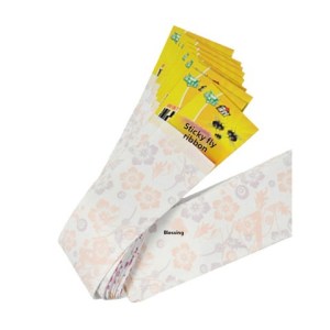 Coiled white floral-patterned ribbon with several yellow sticky fly ribbons protruding from the end.