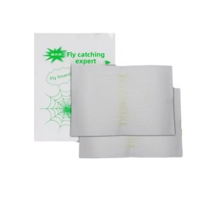 Two white adhesive fly-trap sheets placed beside a white box that reads 'Fly catching expert' with a green spider-web graphic.