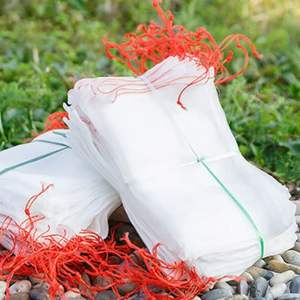 White fruit protection mesh bags with red drawstrings - reusable fruit netting bags