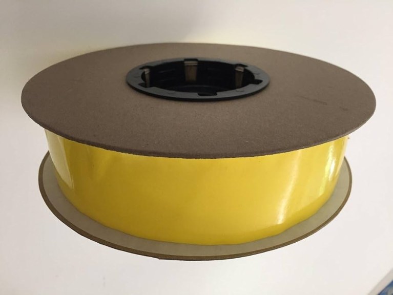 Yellow sticky insect tape roll close-up showing winding for wholesale specification